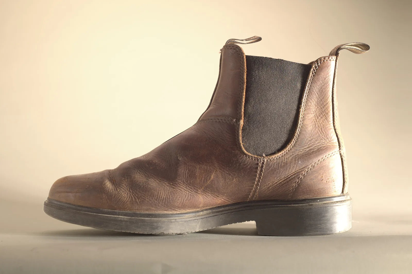 Inner side of a brown Blundstone boot with dry, scuffed leather, before Boot Wax