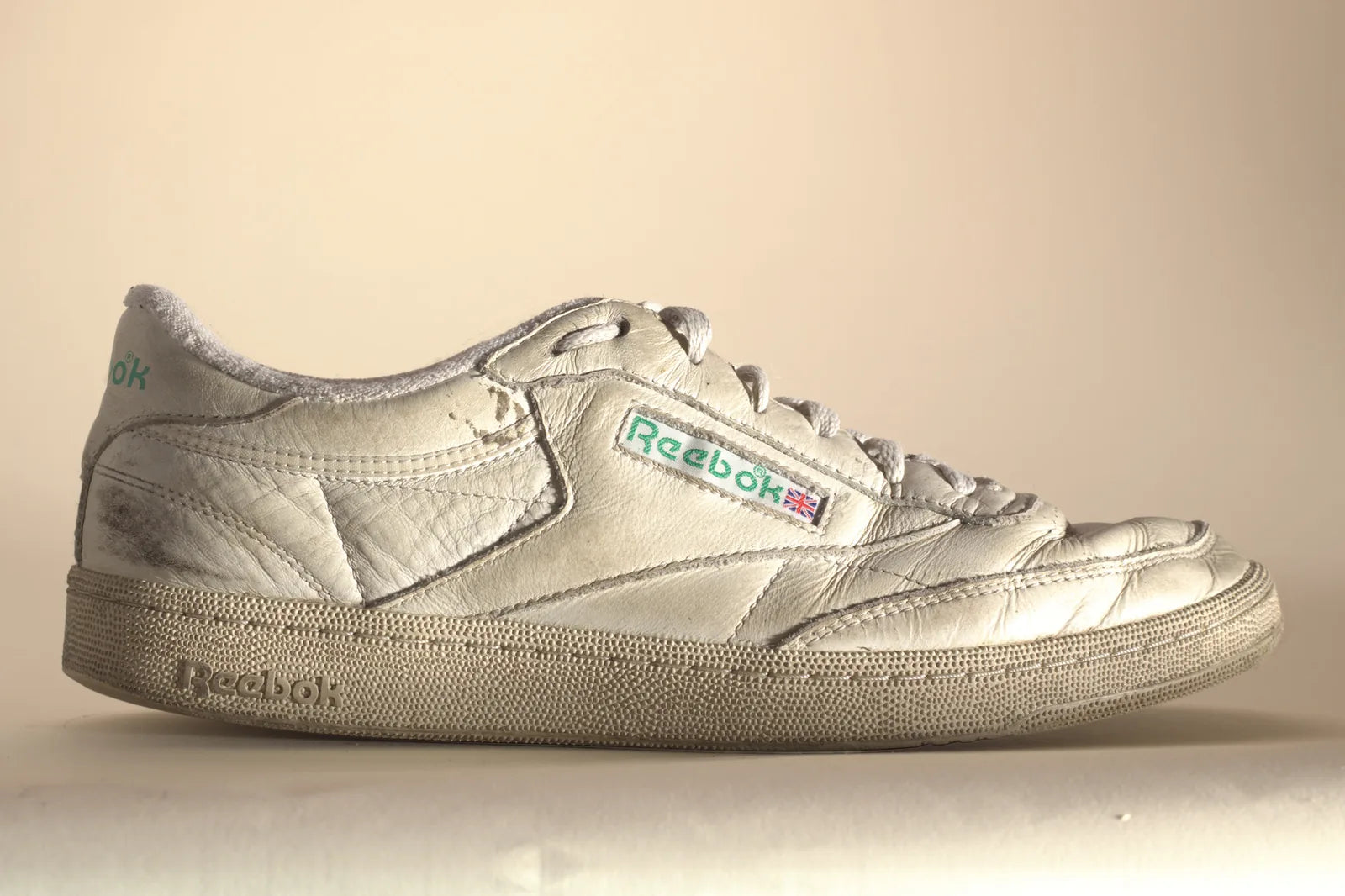 White Reebok sneaker from the outside, with grime on the heel, side panel and toe, before Boot Soap