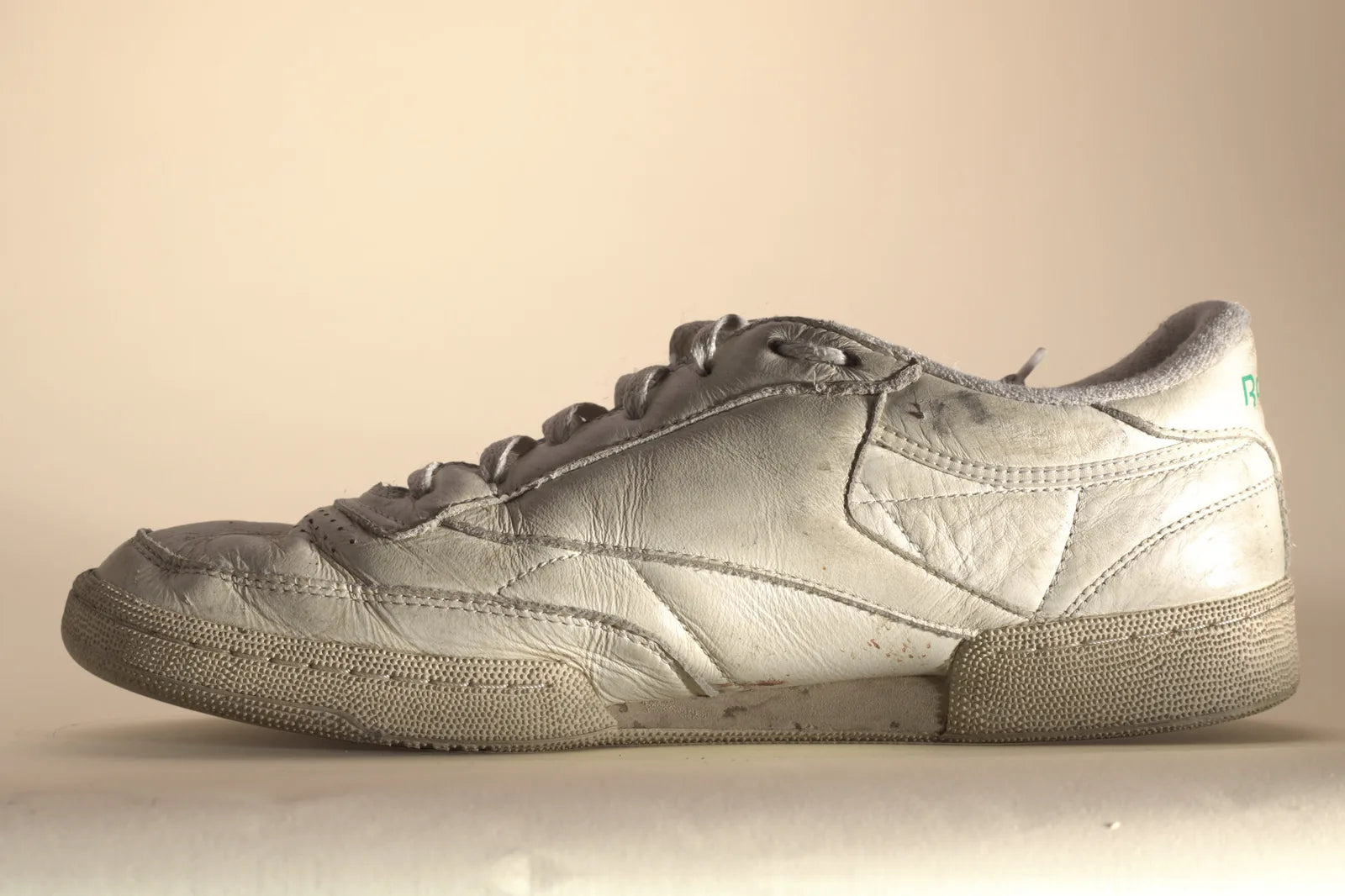 Inside of a white Reebok sneaker with marks on the side panel, before Boot Soap