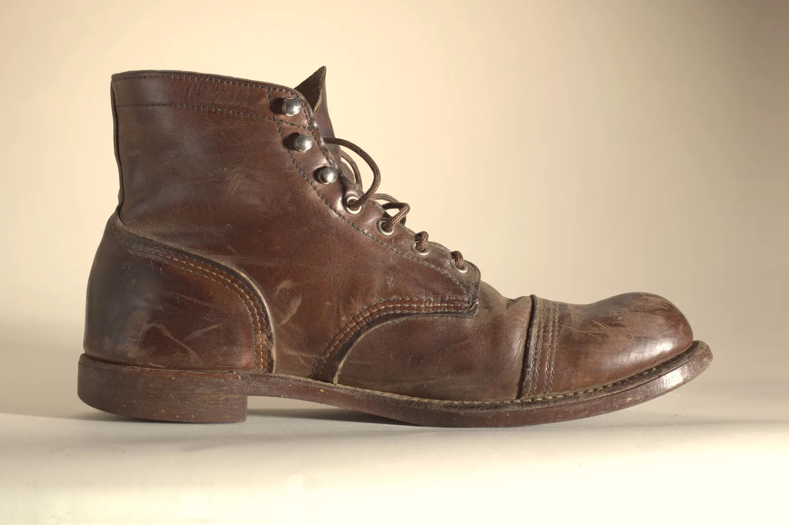 Brown Red Wing boot from the outside, with a scratched heel and pale scuffs on the toe, before Boot Wax