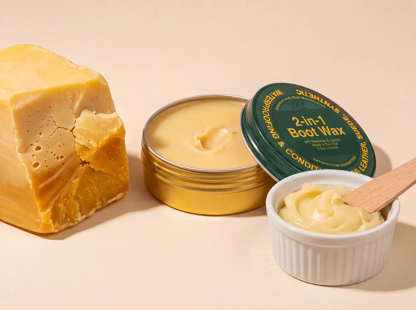 An open tin of 2-in-1 Boot Wax beside a block of beeswax and a dish of lanolin
